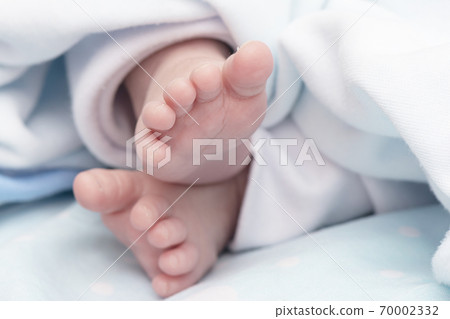 Detail shot of a newborn baby feet peacefully Detail shot of a newborn baby feet peacefully 70002332