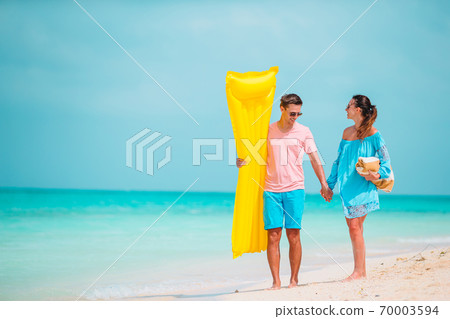 Young couple on white beach during summer vacation. 70003594