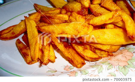 Yellow home made french fries on the white plate 70003975