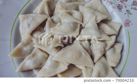 Traditional Turkish cuisine Ravioli, Manti Manlama serving with yogurt and fried butter sauce. Traditional Turkish cuisine Ravioli, Manti Manlama serving with yogurt and fried butter sauce. 70004218