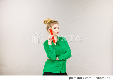 Woman confused thinking, big pencil in hand 70005267