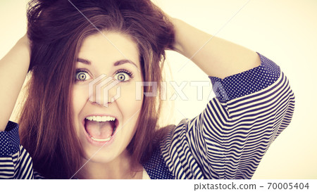 Woman having shocked amazed face expression Woman having shocked amazed face expression 70005404