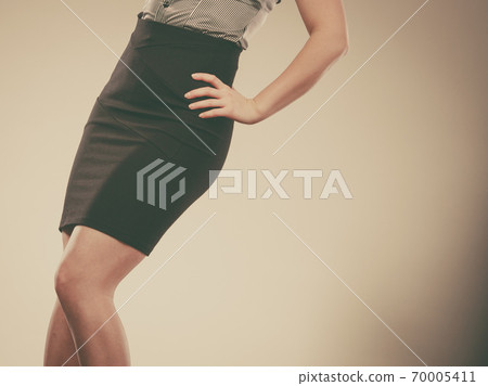 Woman wearing elegant tight dark black skirt Woman wearing elegant tight dark black skirt 70005411