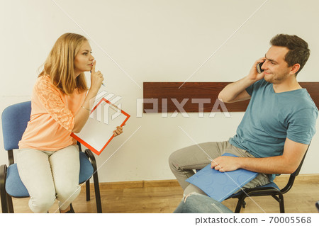 Rude man talking on phone during meeting Rude man talking on phone during meeting 70005568
