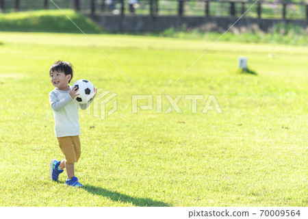 A boy with a soccer ball 70009564