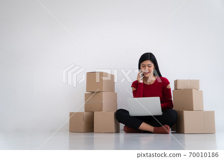 Happy Asian young entrepreneur, Smile for sales success after checking order from online shopping store at home office, Concept of merchant business online, eCommerce and delivery and lifestyle Happy Asian young entrepreneur, Smile for sales success after checking order from online shopping store at home office, Concept of merchant business online, eCommerce and delivery and lifestyle 70010186