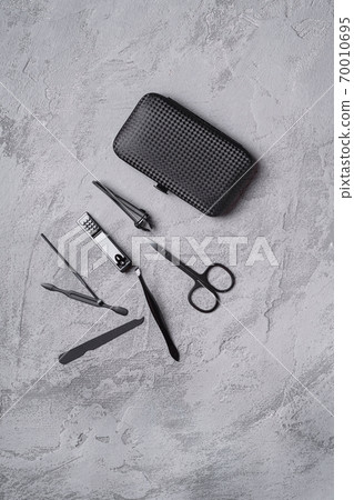 Set of manicure, pedicure tools and accessories with case, stone concrete background, top view 70010695