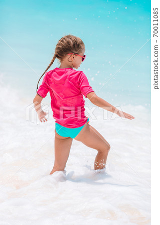 Cute little girl at beach during summer vacation Cute little girl at beach during summer vacation 70011085