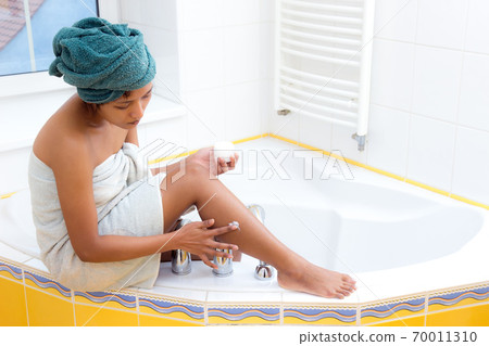woman creams her leg woman creams her leg 70011310