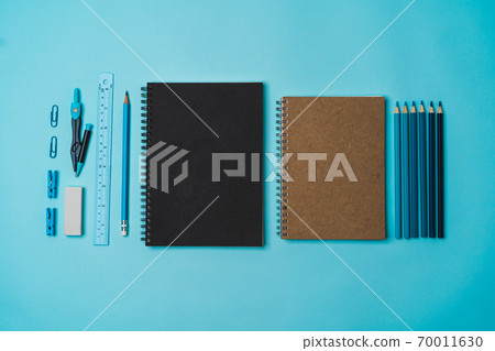 book, pencil, ruler on a blue background. book, pencil, ruler on a blue background. 70011630
