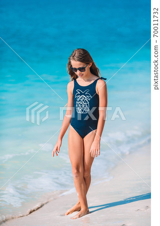 Adorable active little girl at beach during summer vacation 70011732
