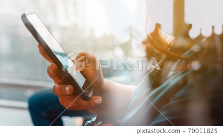 Women Hand holding a smartphone Women Hand holding a smartphone 70011825