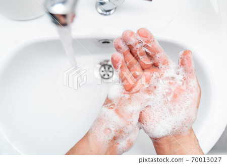 Personal hygiene, cleaning hands with soap often on faucet to protect from virus. Personal hygiene, cleaning hands with soap often on faucet to protect from virus. 70013027