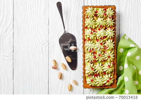 Pistachio ganache tart made of shortcrust pastry Pistachio ganache tart made of shortcrust pastry 70013418
