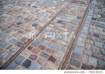 Background square of pavers with old rusty tram rails Background square of pavers with old rusty tram rails 70013610