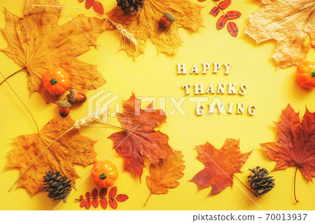 Colorful leaves and pumpkins on yellow frame with copy space. 70013937