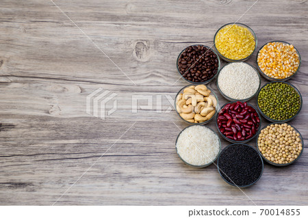 Cereal grains seeds beans on wooden background.  70014855