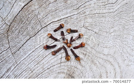 Cloves (flower buds of Syzygium aromaticum). Clipping paths, shadow separated on wood ;herb for health.;top view. 70014877