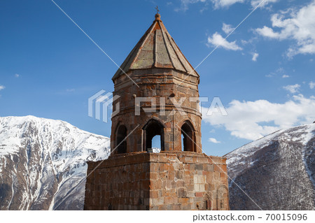 Trinity Church of Gergeti is under cloudy sky. Georgia 70015096