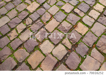 Ancient old yellow grey white stone road background 70016252