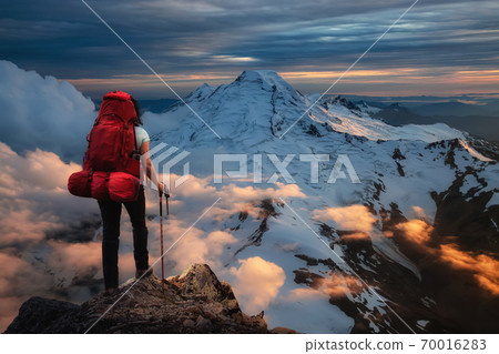 Backpacking on top of a mountain Cliff. Backpacking on top of a mountain Cliff. 70016283