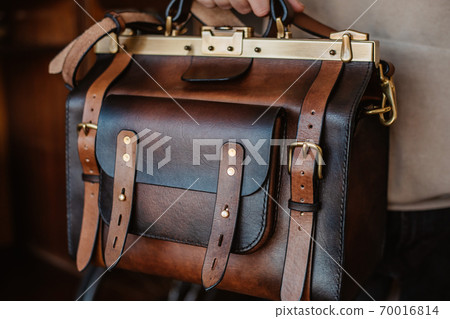 Business man holding elegant brown leather briefcase. Business man holding elegant brown leather briefcase. 70016814