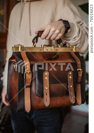 Business man holding elegant brown leather briefcase. Business man holding elegant brown leather briefcase. 70016823