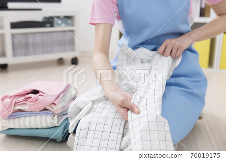 woman folding laundry 70019175