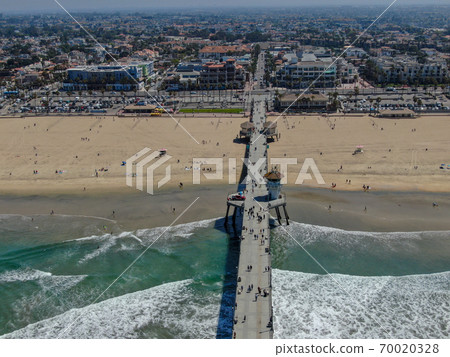 Aerial view of Huntington Pier, beach and coastline during sunny summer day 70020328