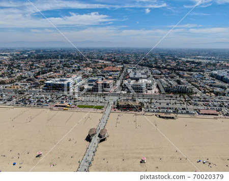 Aerial view of Huntington Pier, beach and coastline during sunny summer day 70020379