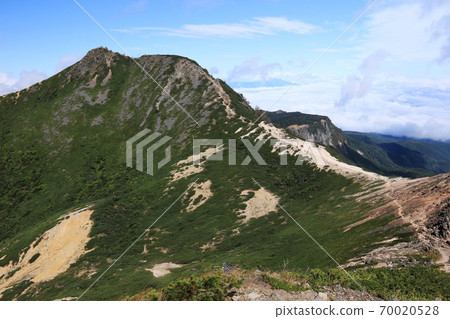Yatsugatake mountain range in early autumn, Mt. Higashi Tengu from Mt. Neishi, overlooking the summit of "Nyu" and Mt. Inako in the distance 70020528