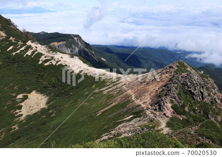 View of the summit of "Nyu" and Mt. Inako in the distance from Mt. Neishi, the Yatsugatake mountain range in early autumn View of the summit of "Nyu" and Mt. Inako in the distance from Mt. Neishi, the Yatsugatake mountain range in early autumn 70020530