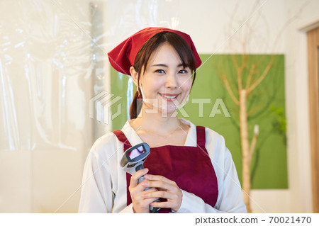 A clerk standing in a store with a vinyl partition A clerk standing in a store with a vinyl partition 70021470