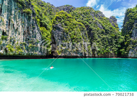 Young man snorkel diving at Phi Phi island, Thailand. 70021738