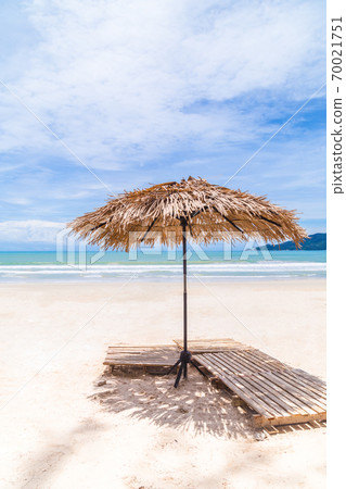Beach Umbrella made of palm leafs on a perfect white beach in front of Sea in Thailand. Beach Umbrella made of palm leafs on a perfect white beach in front of Sea in Thailand. 70021751