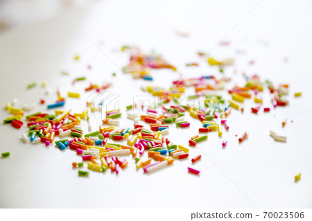 Selective focus colorful sugar sprinkle dots for decoration topping cake and ice cream on the table. Selective focus colorful sugar sprinkle dots for decoration topping cake and ice cream on the table. 70023506