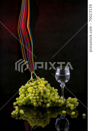 Still life with grapes and wine in glasses Still life with grapes and wine in glasses 70023539