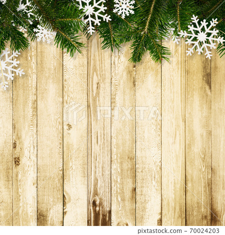 Wood grain background decorated with fir tree and snow ornaments-there are multiple variations Wood grain background decorated with fir tree and snow ornaments-there are multiple variations 70024203