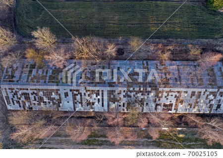 Abandoned derelict industrial greenhouse ruins in autumn, aerial 70025105