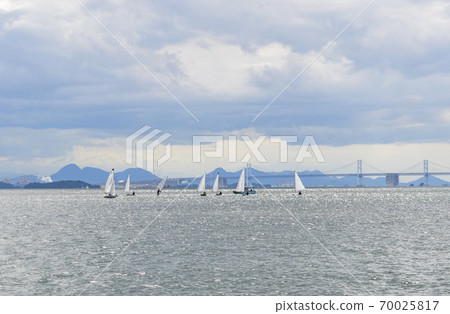 People who enjoy marine sports such as yachting in the sea near Seto Ohashi People who enjoy marine sports such as yachting in the sea near Seto Ohashi 70025817