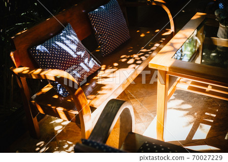 Garden wooden furniture for leisure time in nature. Cushions is on the chair.  70027229