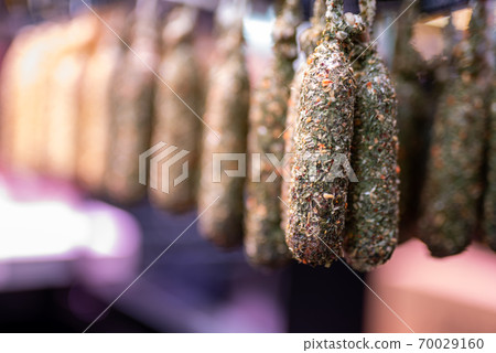 Catalan dry sausages with blurred background, on food market in Barcelona 70029160