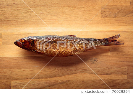 Smocked herring on a wooden table. 70029294