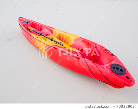 Red kayak on white sand beach at beauty day light, Travel plans in holidays or after retirement Red kayak on white sand beach at beauty day light, Travel plans in holidays or after retirement 70032902