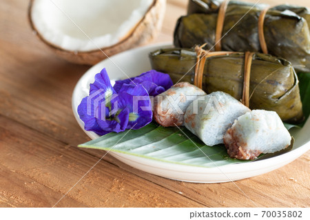 Thai traditional dessert Sticky Rice with Bananas (Khao Tom Mat) on wooden background Thai traditional dessert Sticky Rice with Bananas (Khao Tom Mat) on wooden background 70035802
