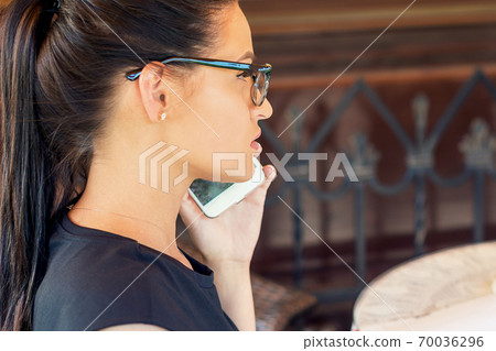 Busy business woman talking on the smartphone 70036296