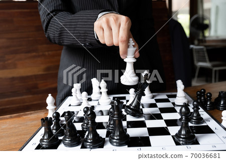 Business women holding king chess on board with white background, challenges planning business strategy to success concept Business women holding king chess on board with white background, challenges planning business strategy to success concept 70036681