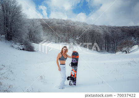 Female snowboarder hold snowboard and going to snowboarding 70037422