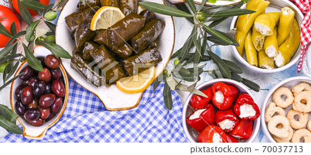 Turkish cabbage rolls and various snacks of national cuisine. Rice in grape leaves and olives. Food 70037713