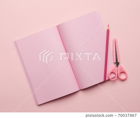 open notebook with blank pink pages on a pink background 70037867